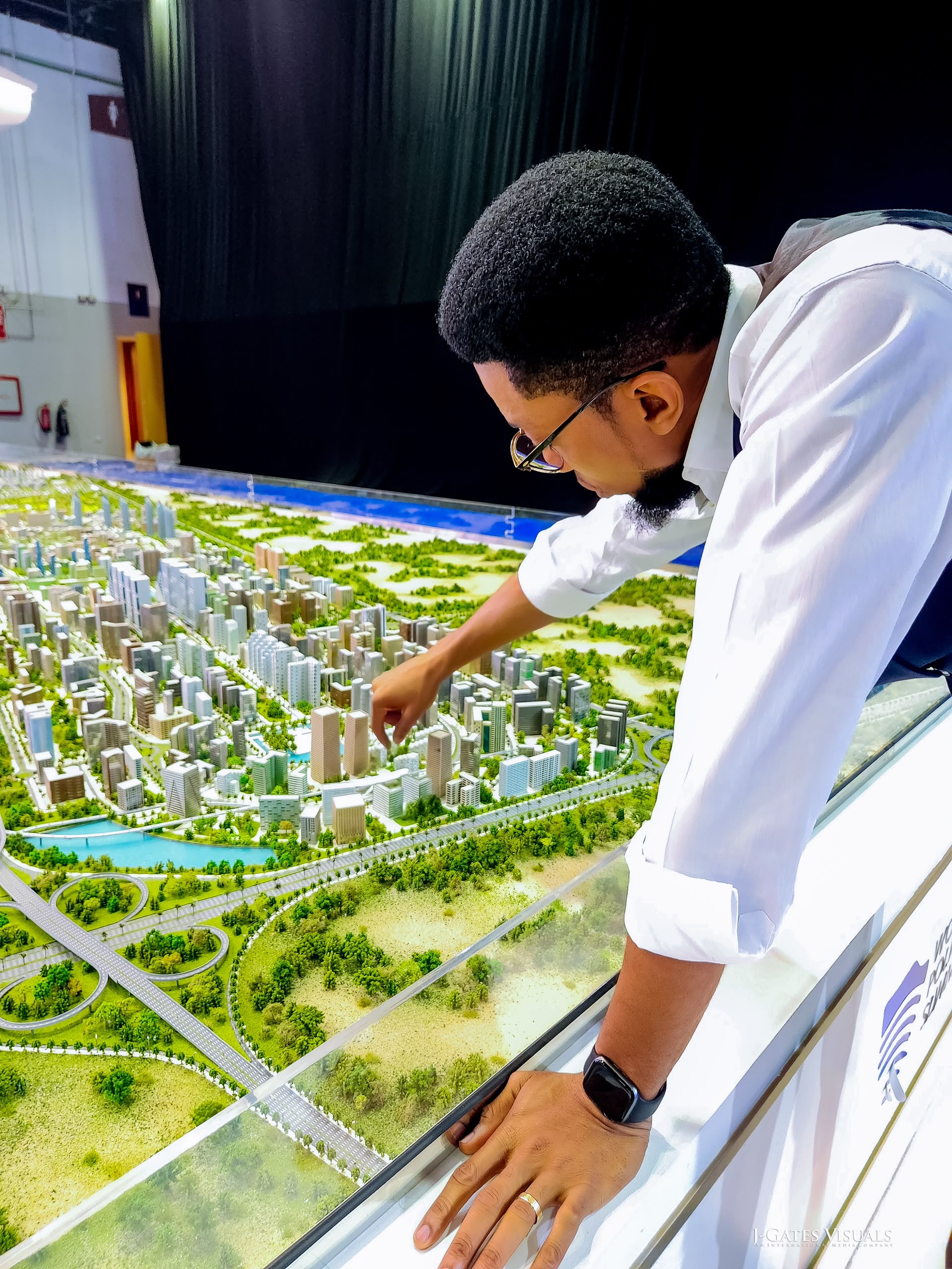 Chukwudi Ezenwa reviewing an architectural master plan model