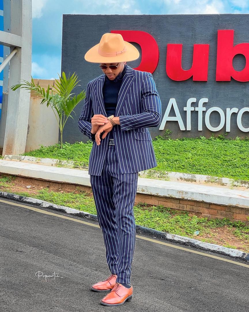 At Dubai Estate in pinstripe suit