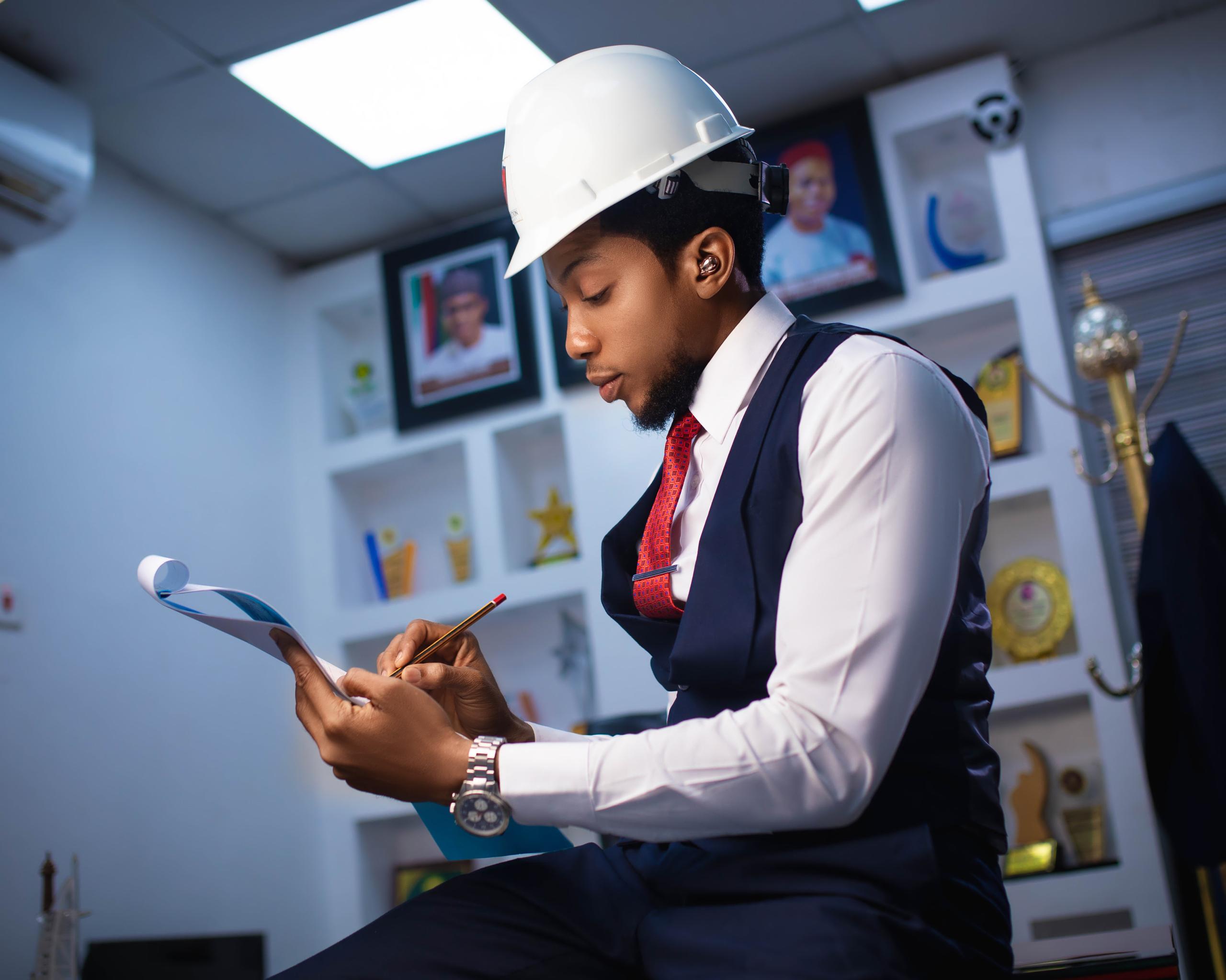 Reviewing blueprints in hard hat